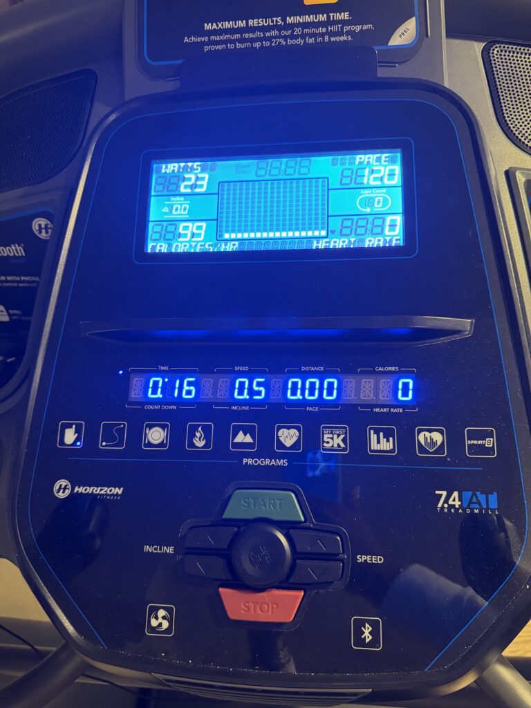 Horizon treadmill with console on with workout metrics